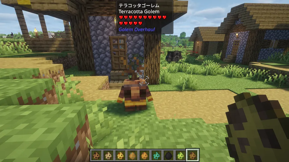 Golem Overhaul Modの「テラコッタゴーレム」。村の入口に佇む、茶色と黄色の模様が入った焼き物のような質感の小さなゴーレム。頭からは小さな芽が生えており、素朴な工芸品のような姿をしている。
