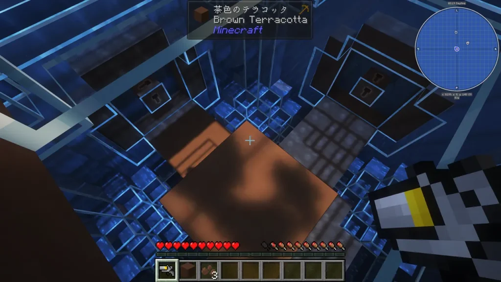 茶色のテラコッタが配置された、海中に浮かぶガラス張りの拠点「スフィア」の内部構造を上空から見下ろした視点。